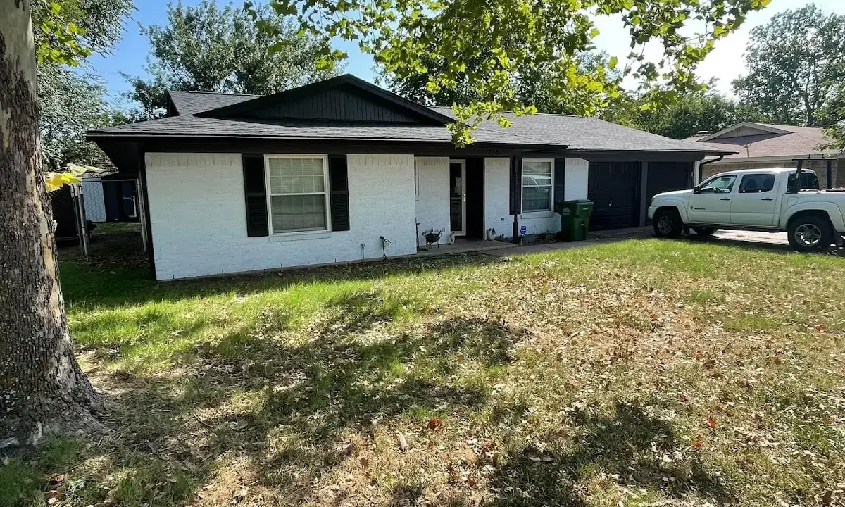 Professional roofing crew working on a residential roof in Milford